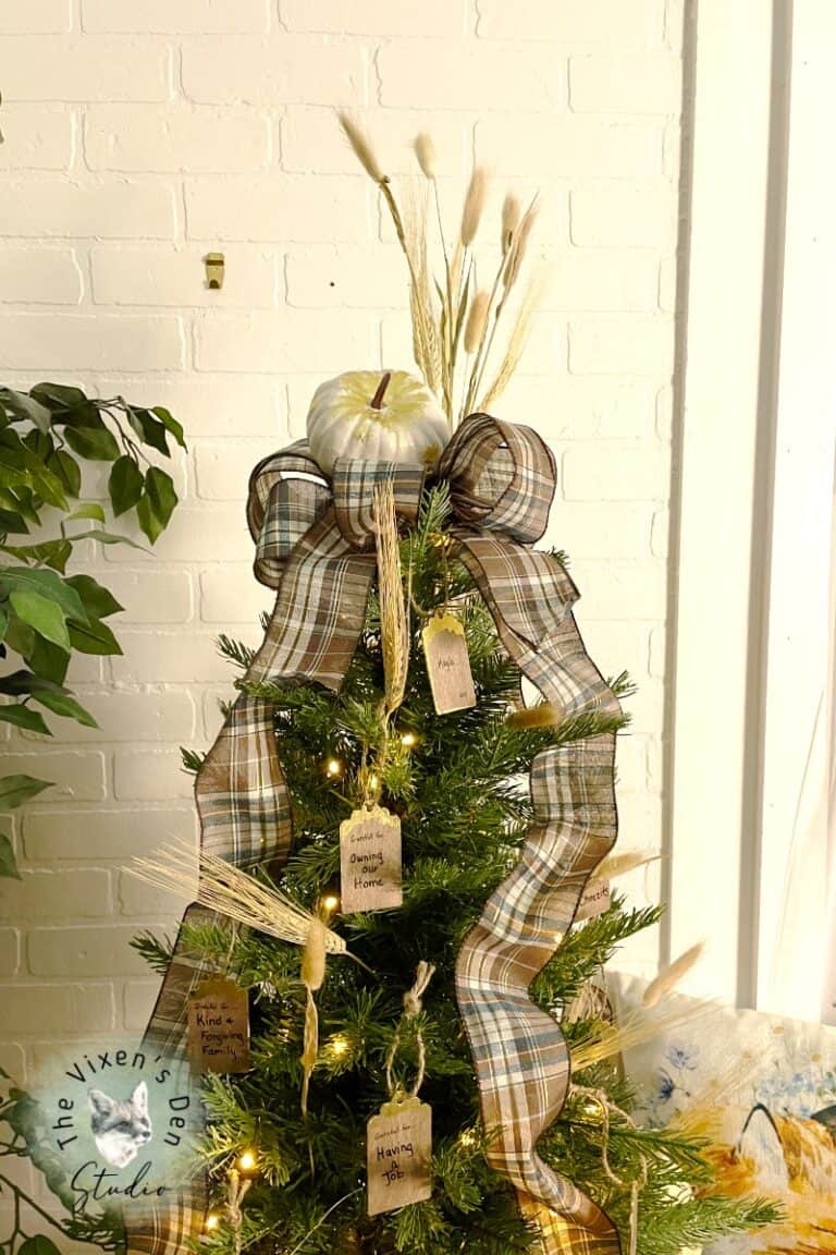A christmas tree decorated with a plaid ribbon.