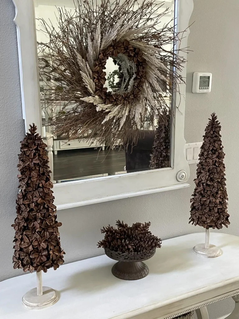 Pinecone wreath and pinecones on a white table.