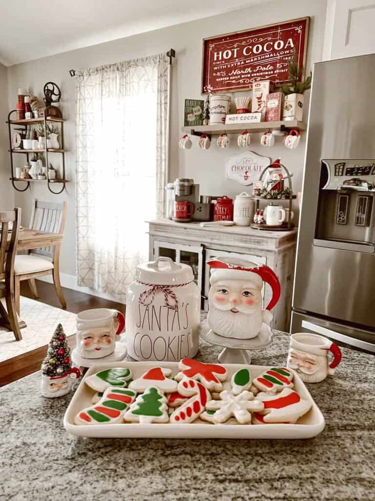 Santa claus cookies on a tray in a kitchen.