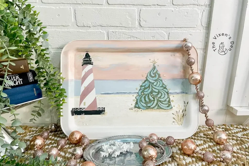 A tray with a painting of a lighthouse on it.