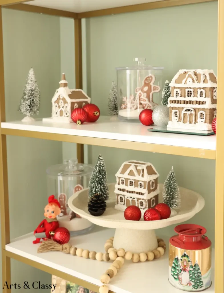 A shelf with christmas decorations and gingerbread houses.