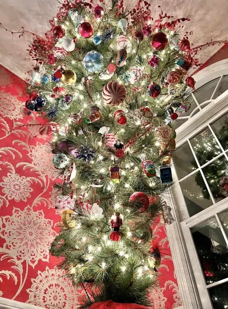 A christmas tree decorated with ornaments in a room.