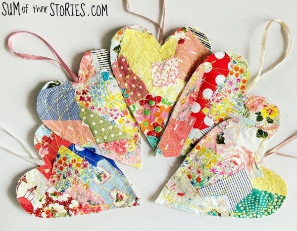 Quilted heart ornaments made from fabric scraps.