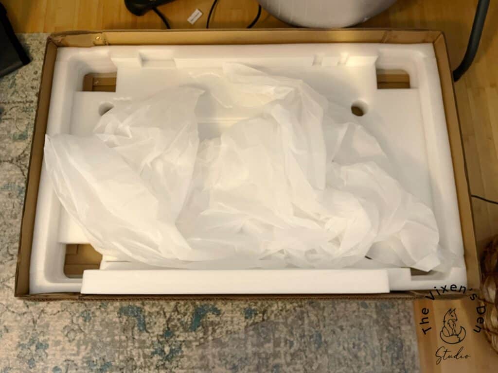 A box with a white bag on top of it.