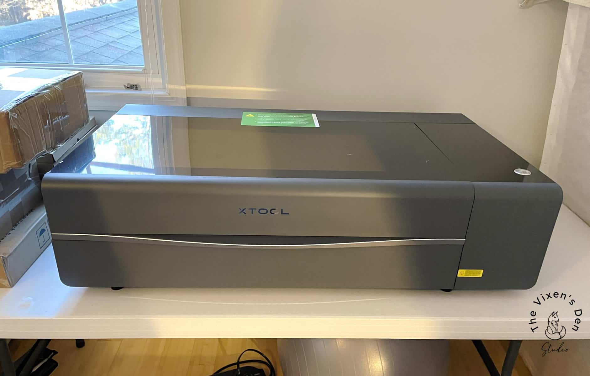 A laser printer sitting on a table in a room.