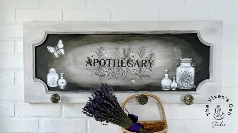 Vintage-style "apothecary" signboard with botanical illustrations and a bunch of lavender on a white brick wall.
