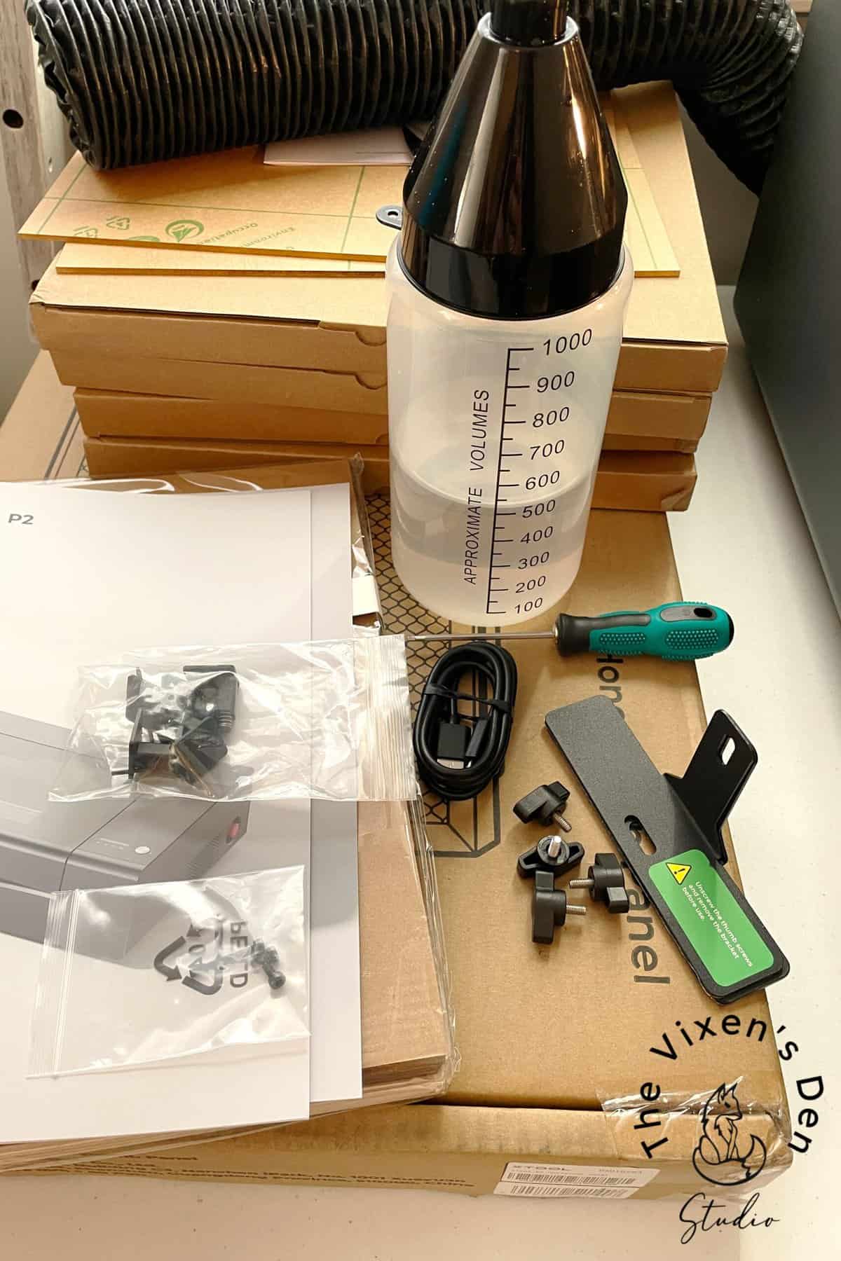 A box with a bottle and screwdriver.
