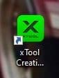 Desktop shortcut icon for "xTool Creations," featuring a green square with a black "X" and partially visible text.