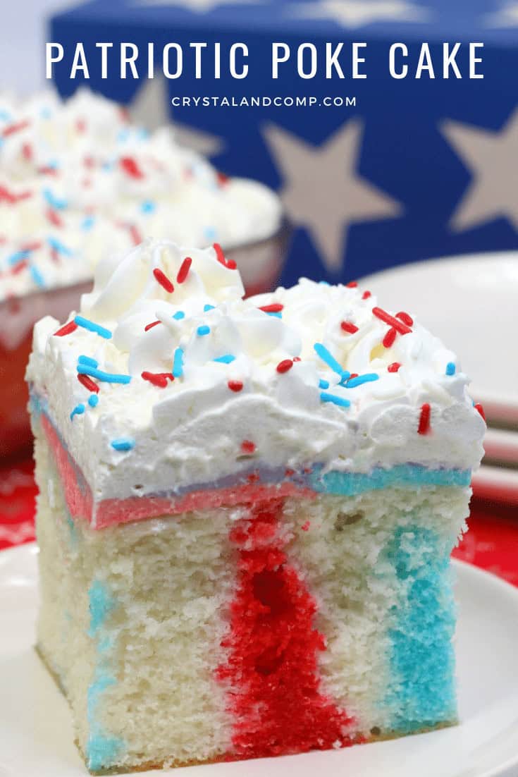 A slice of patriotic poke cake with red, white, and blue colors, topped with whipped cream and sprinkles, against a background featuring stars.