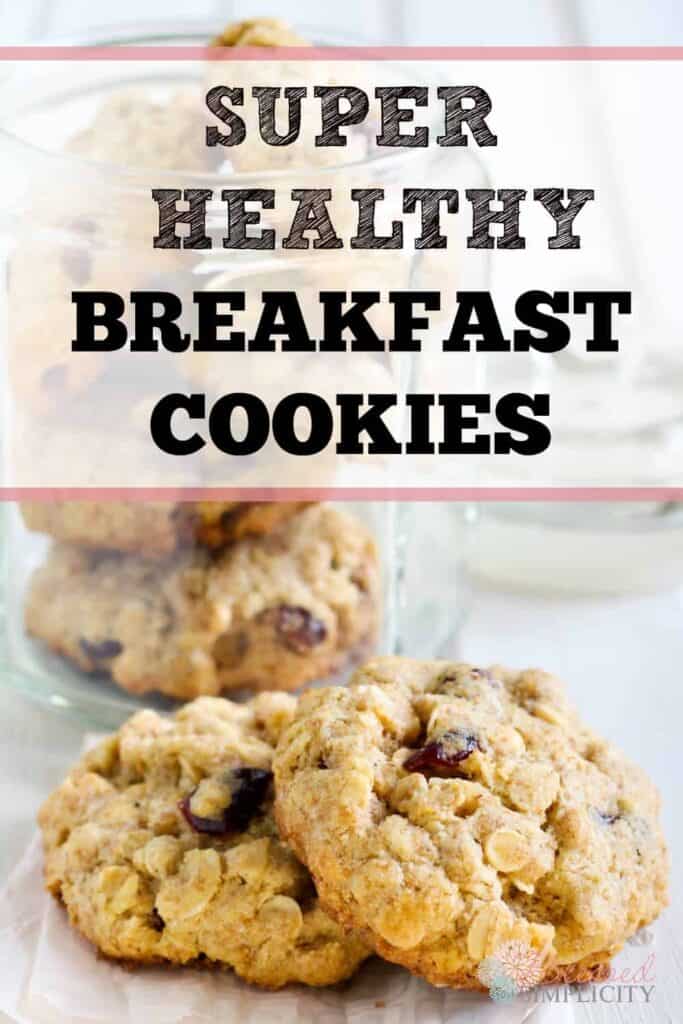 A close-up of oatmeal cookies placed on a table and in a glass jar behind them. The text on the image reads "Super Healthy Breakfast Cookies.