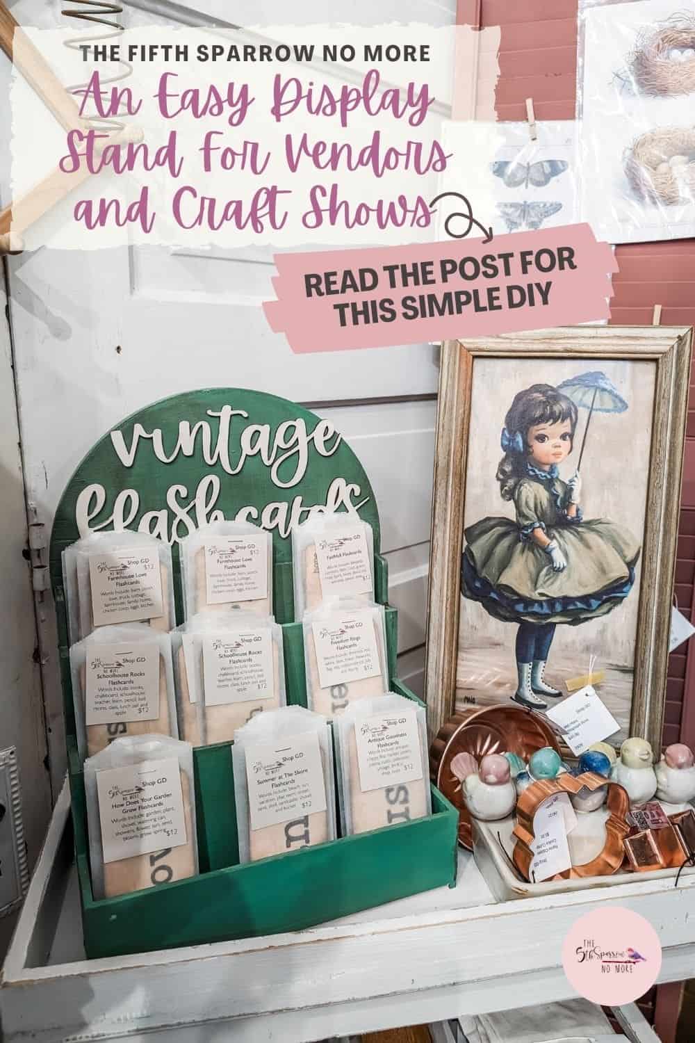 A display stand with "Vintage Flashcards" in labeled envelopes, next to a framed vintage-style painting of a girl. Text reads: "An Easy Display Stand For Vendors and Craft Shows.