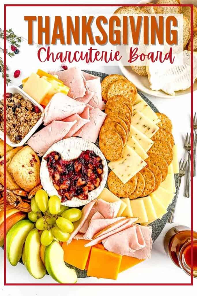 An assortment of meats, cheeses, crackers, and fruits arranged on a Thanksgiving-themed charcuterie board with text at the top.