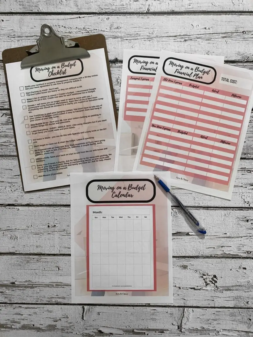 Budget planning worksheets are laid out on a wooden surface, including a checklist, financial plan, and calendar, with a clipboard and a pen nearby.