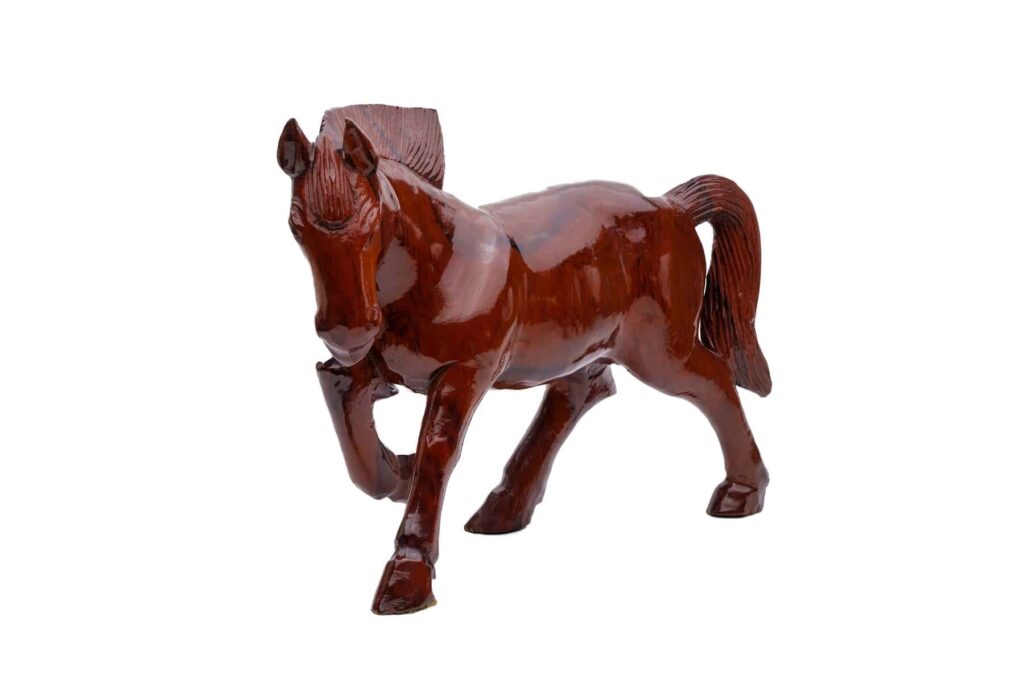 A polished brown wooden horse figurine with one front leg raised, displayed on a white background.
