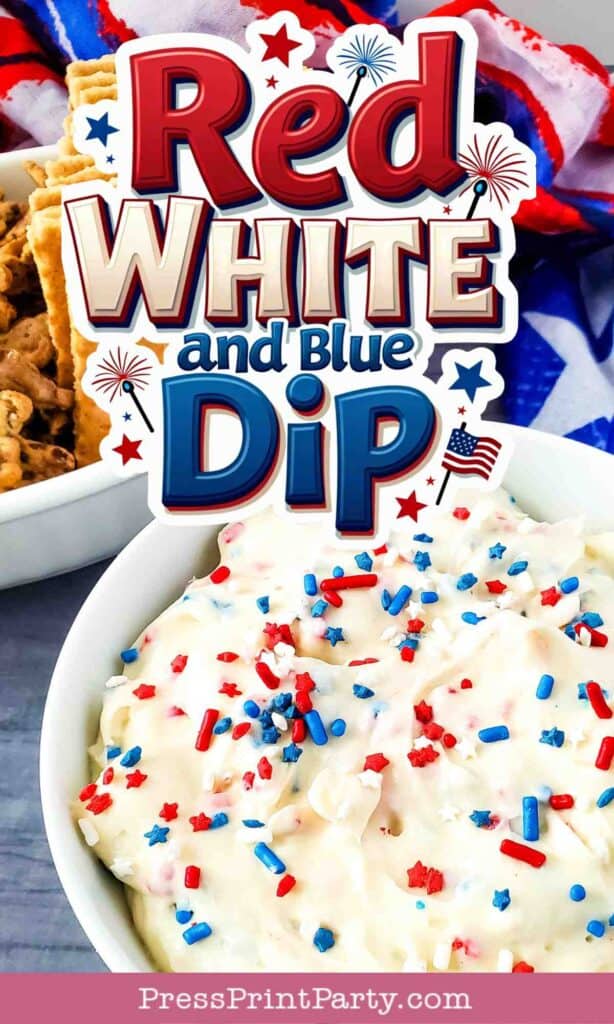 A bowl of dip topped with red, white, and blue sprinkles sits in front of a sign that reads “Red White and Blue Dip,” next to crackers and a festive cloth.
