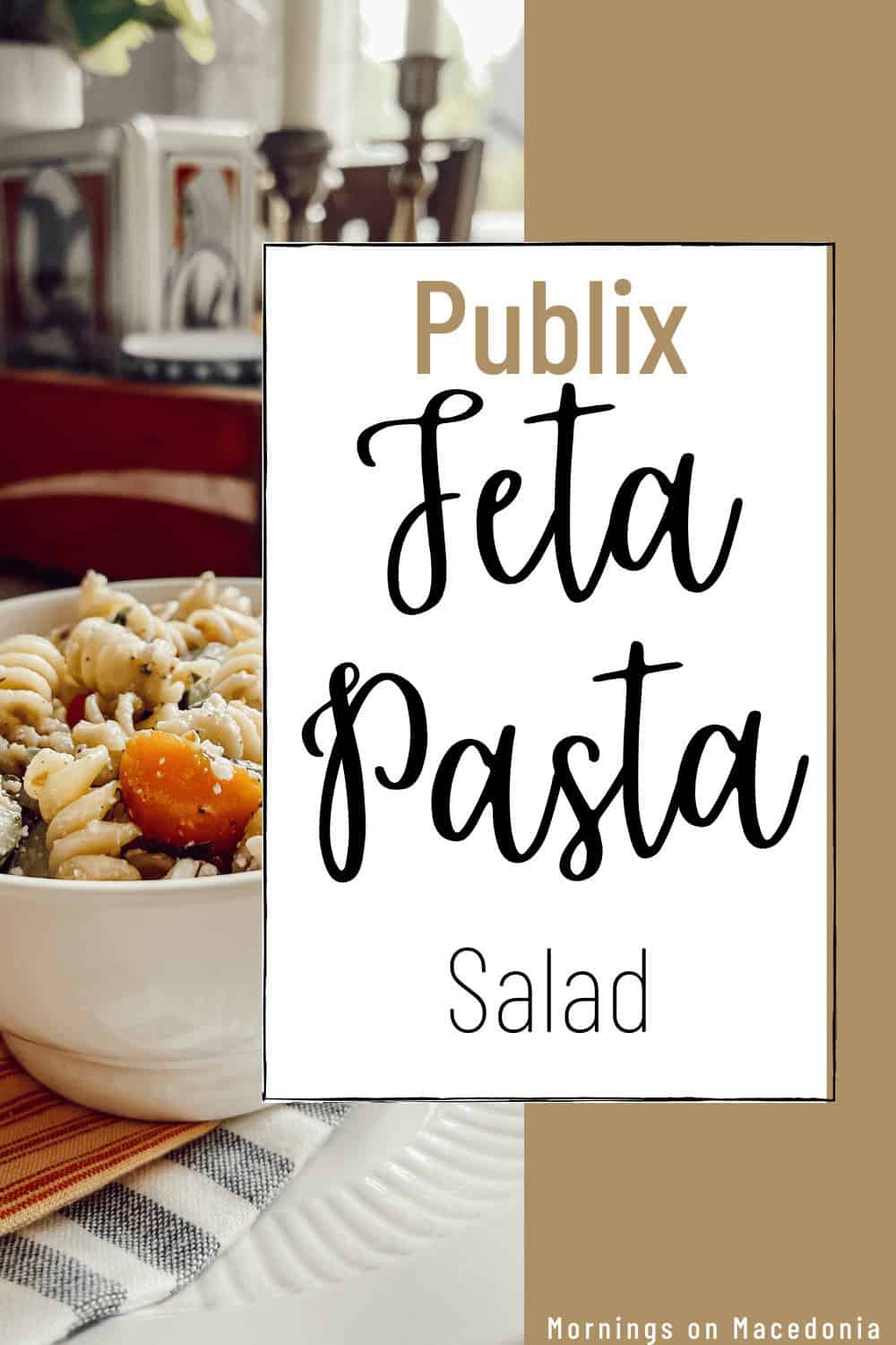 A bowl of feta pasta salad sits on a table with a plaid napkin; a large sign reads "Publix Feta Pasta Salad.