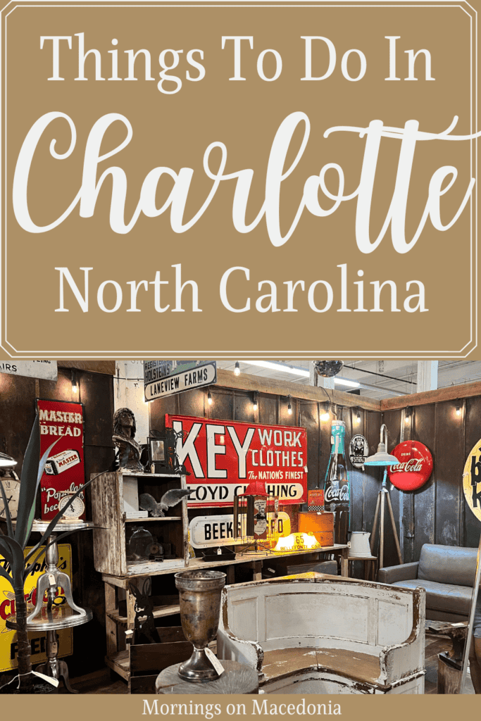A display of vintage signs, furniture, and decor items inside a shop; text above reads "Things To Do In Charlotte, North Carolina.
