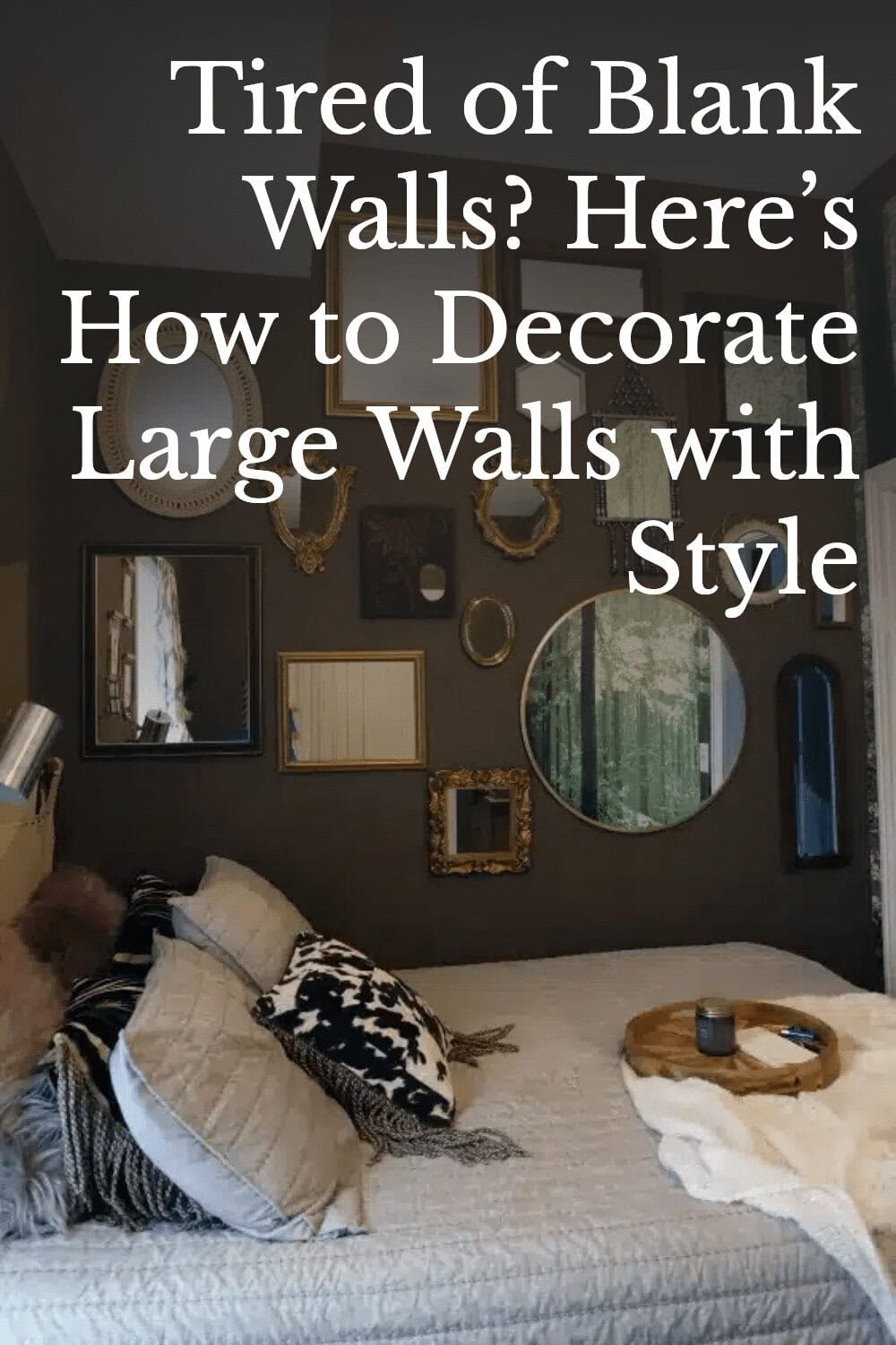 A bedroom with a brown wall decorated with various framed mirrors and art above a bed with patterned pillows and a small wooden side table.