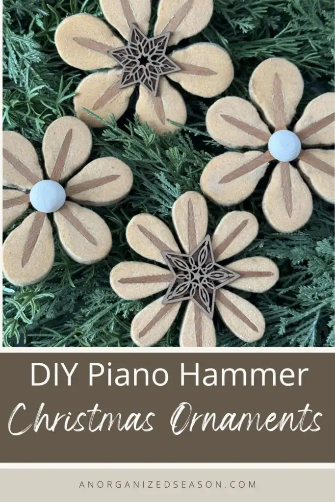 Three flower-shaped Christmas ornaments made from piano hammers rest on green pine branches, with text reading "DIY Piano Hammer Christmas Ornaments.